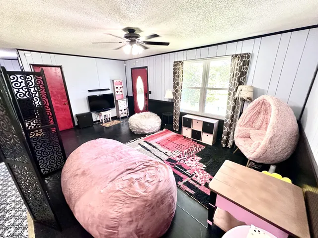 a view of a livingroom with furniture and a window