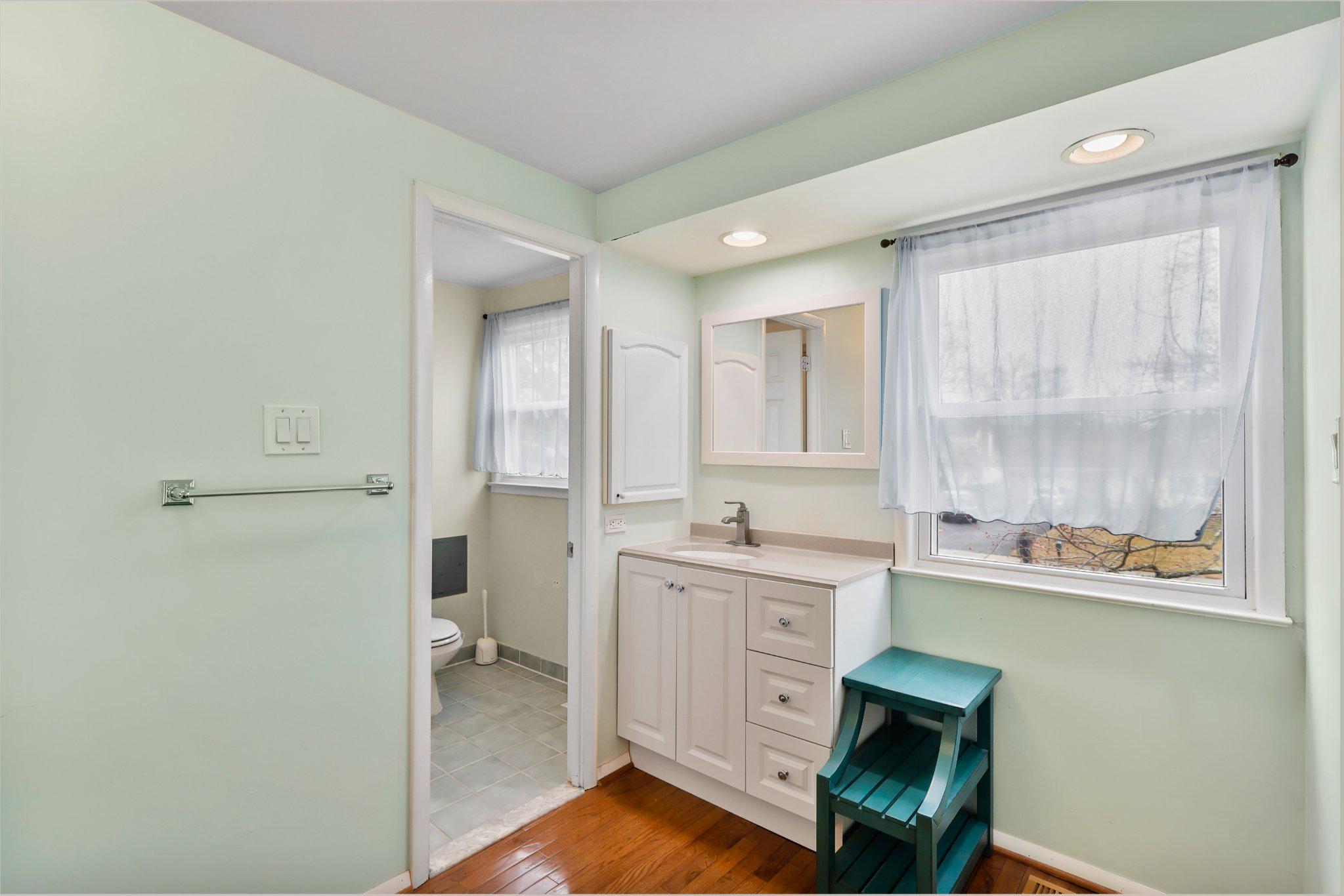 4228 Pageant Lane Fairfax, VA 22033 - Photo 22 of 33 a kitchen with a sink cabinets and wooden floor