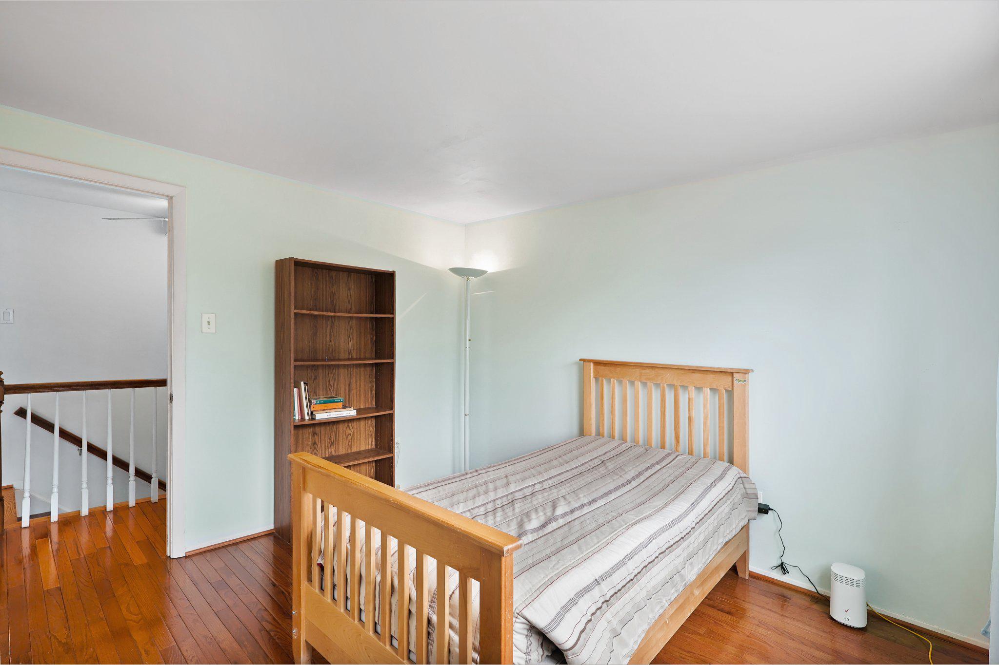 4228 Pageant Lane Fairfax, VA 22033 - Photo 24 of 33 a bedroom with a bed and wooden floor