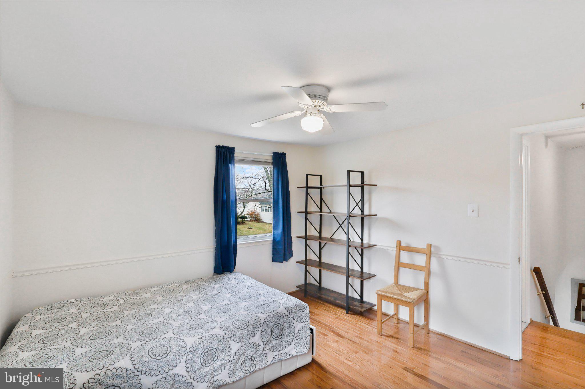 4228 Pageant Lane Fairfax, VA 22033 - Photo 28 of 33 a spacious bedroom with a bed and a table in it
