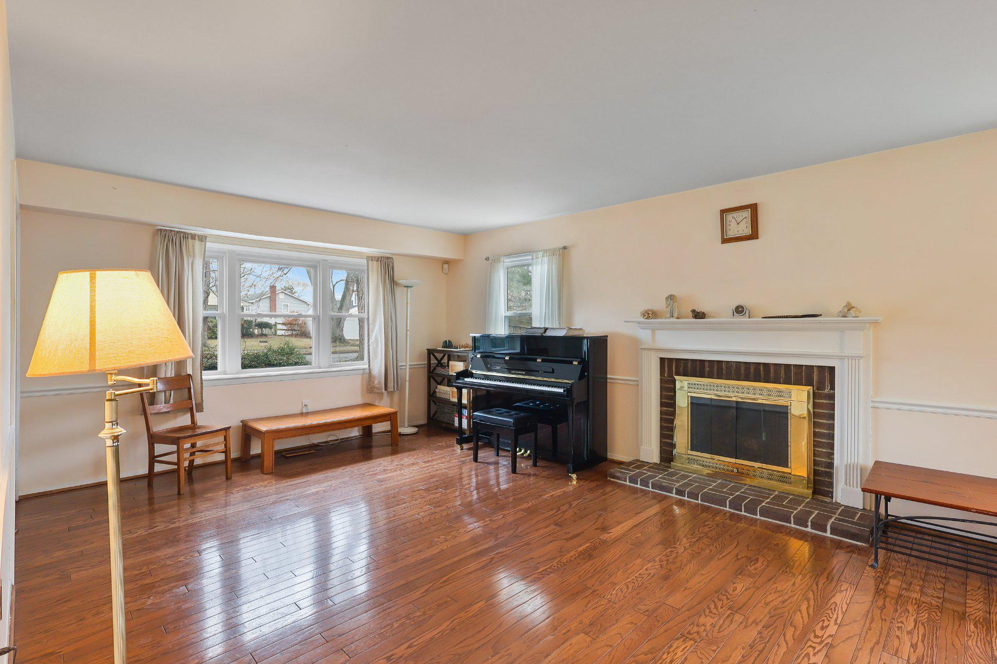 4228 Pageant Lane Fairfax, VA 22033 - Photo 3 of 33 a living room with furniture a fireplace and next to a window