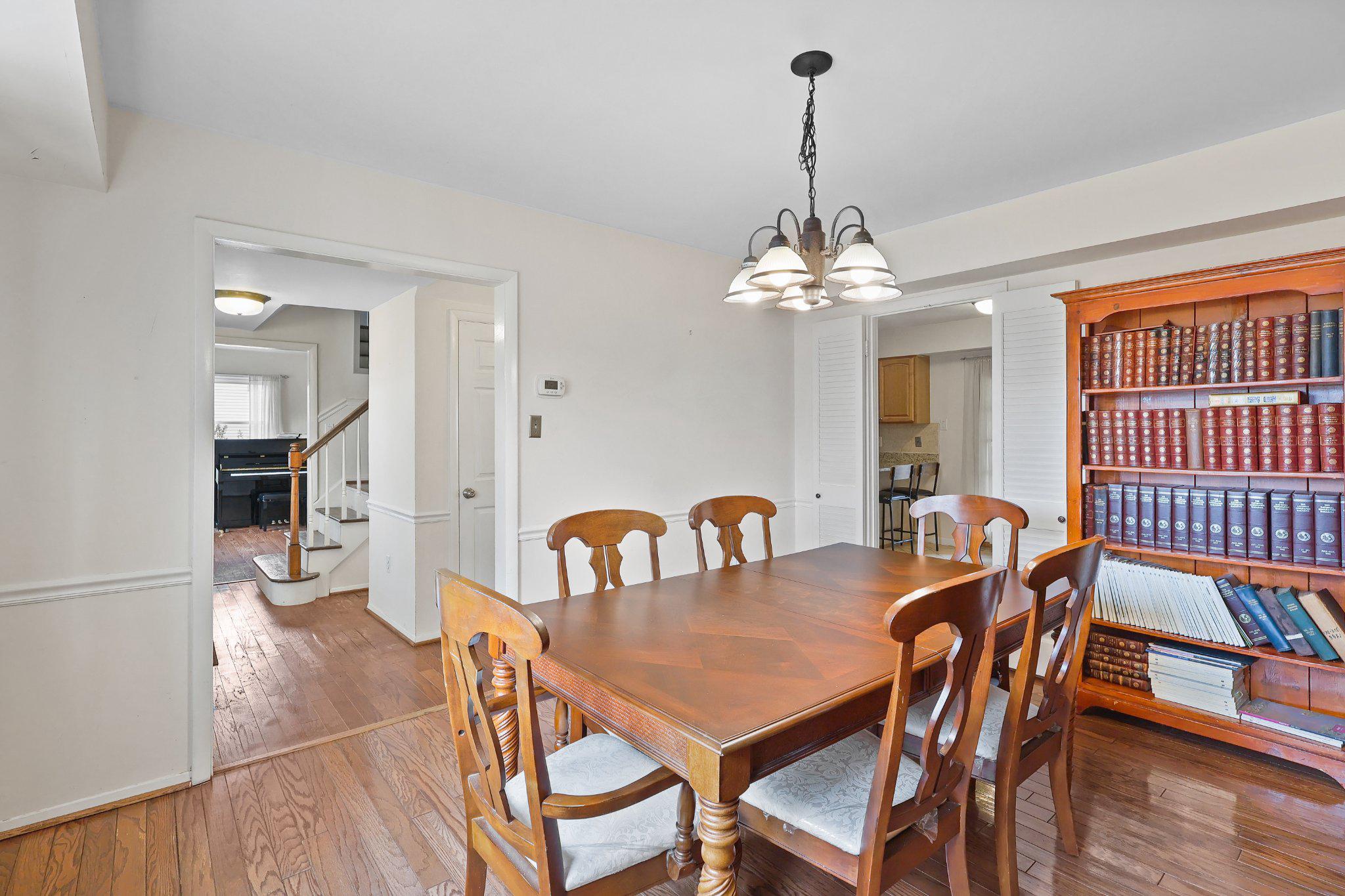 4228 Pageant Lane Fairfax, VA 22033 - Photo 5 of 33 a dining room with furniture a chandelier and wooden floor
