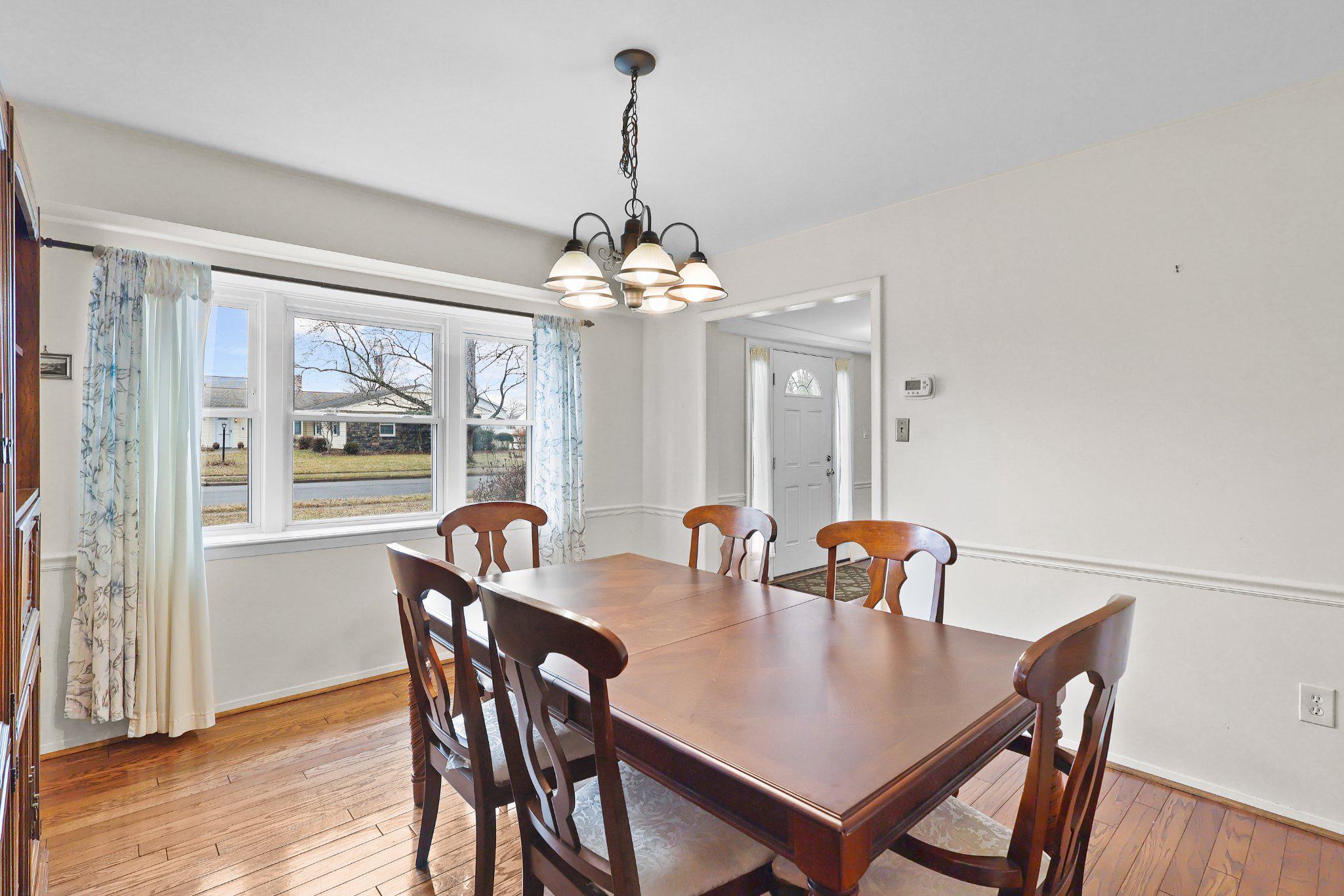 4228 Pageant Lane Fairfax, VA 22033 - Photo 7 of 33 a dining room with furniture wooden floor and a chandelier