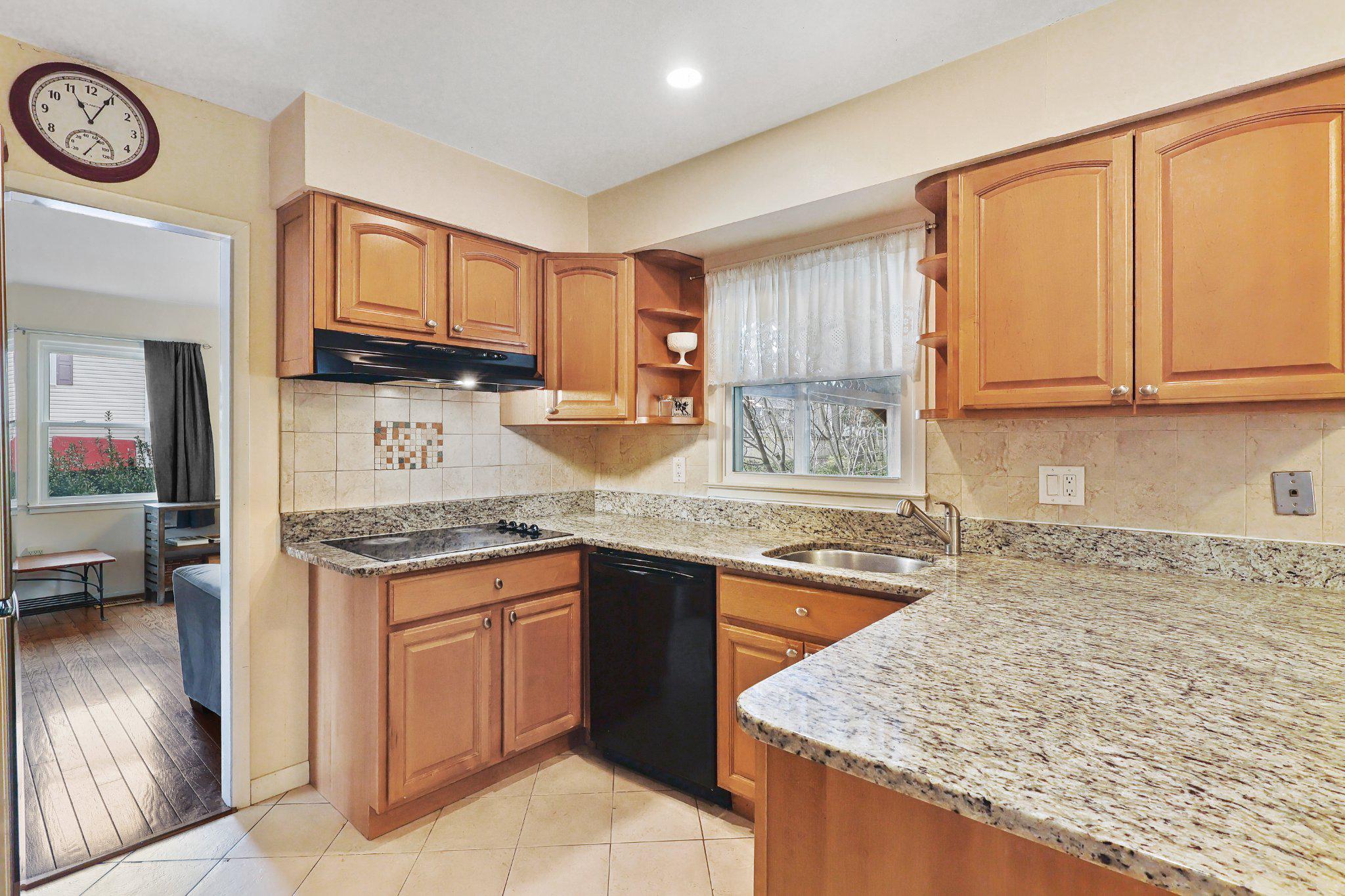 4228 Pageant Lane Fairfax, VA 22033 - Photo 9 of 33 a kitchen with granite countertop a sink a stove top oven a clock and cabinets