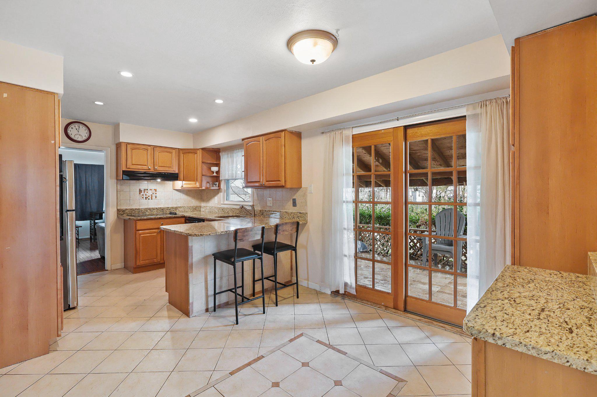 4228 Pageant Lane Fairfax, VA 22033 - Photo 10 of 33 a open kitchen with granite countertop a refrigerator and a sink