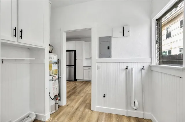 a view of a kitchen with wooden floor and a window