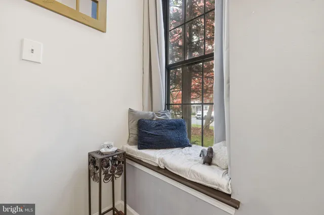 a bathroom with a granite countertop sink and a window