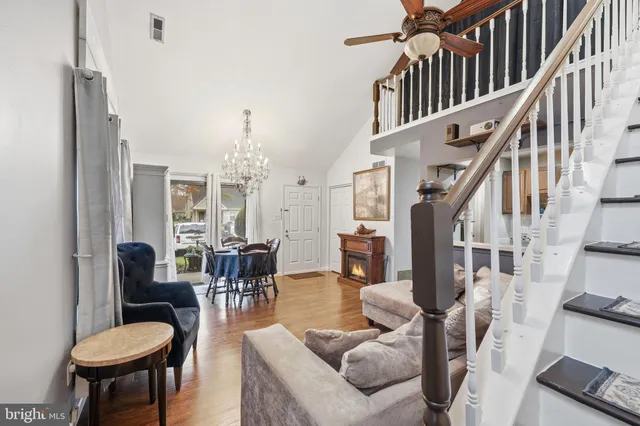 a living room with fireplace furniture and a chandelier