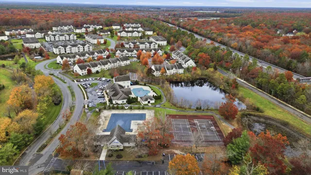 an aerial view of a residential houses with outdoor space