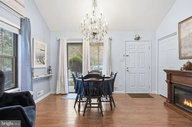 a view of a dining room with furniture and chandelier