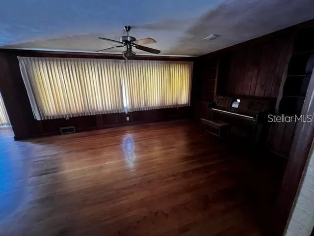 wooden floor in an empty room with a window