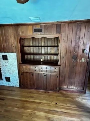a view of a utility room with wooden walls
