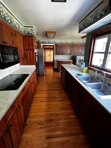 a kitchen with wooden cabinets and sink