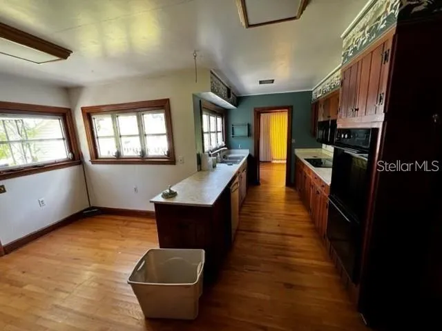 a view of a living room with furniture and a wooden floor