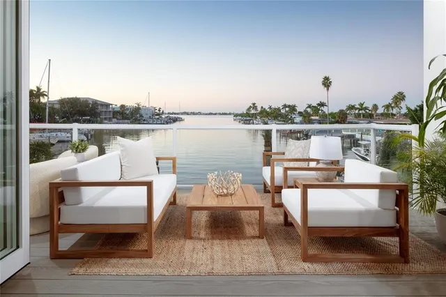 a white bench sitting next to a lake