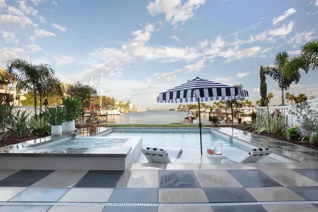 a view of swimming pool with seating space and barbeque oven