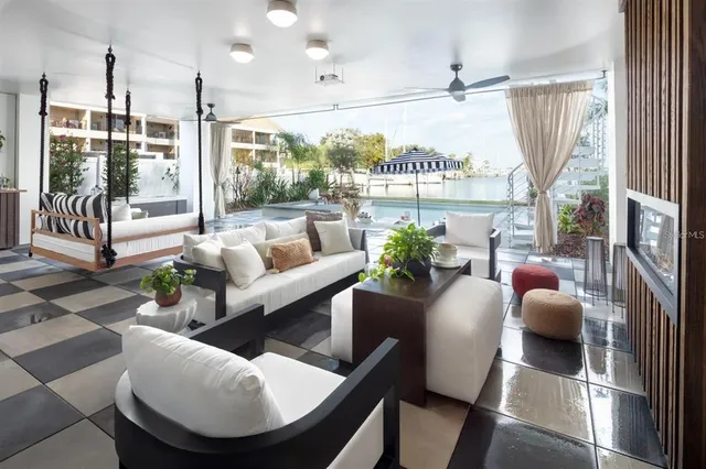 a living room with furniture and a floor to ceiling window