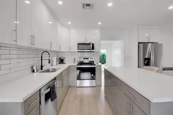 a kitchen with a sink stove and refrigerator