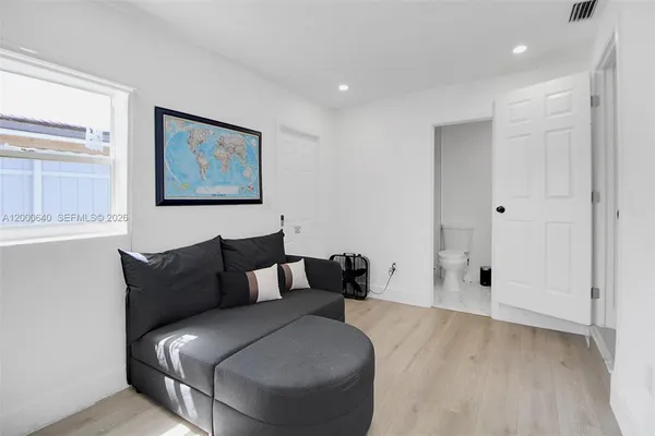 a living room with furniture and wooden floor