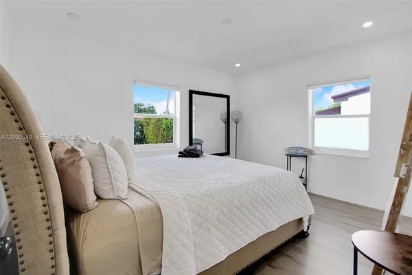 a bedroom with bed and window