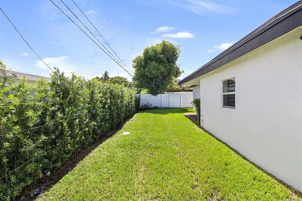 a view of a backyard with potted plants