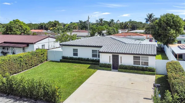 a aerial view of a house with a yard