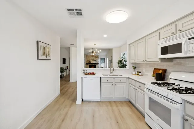 a kitchen with sink cabinets and stainless steel appliances