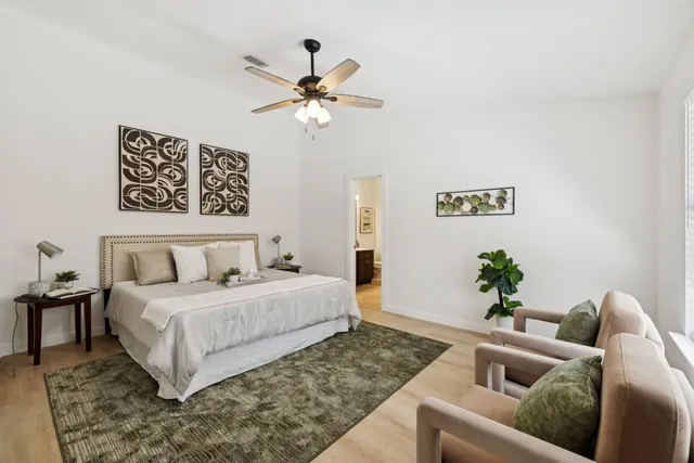 a living room with a bed and a chandelier