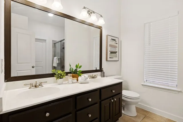 a bathroom with a double vanity sink and a mirror