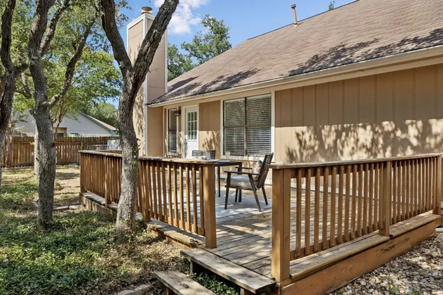a view of a house with wooden fence