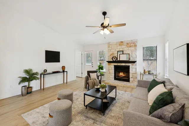 a living room with furniture a fireplace and a flat screen tv