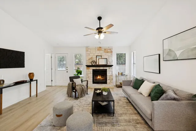a living room with furniture a fireplace and a flat screen tv