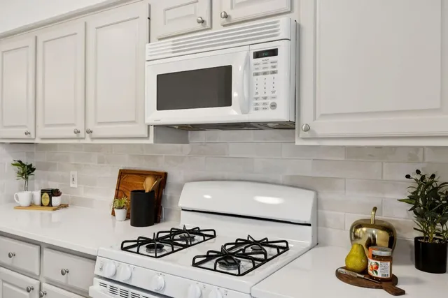 a kitchen with a stove and a microwave