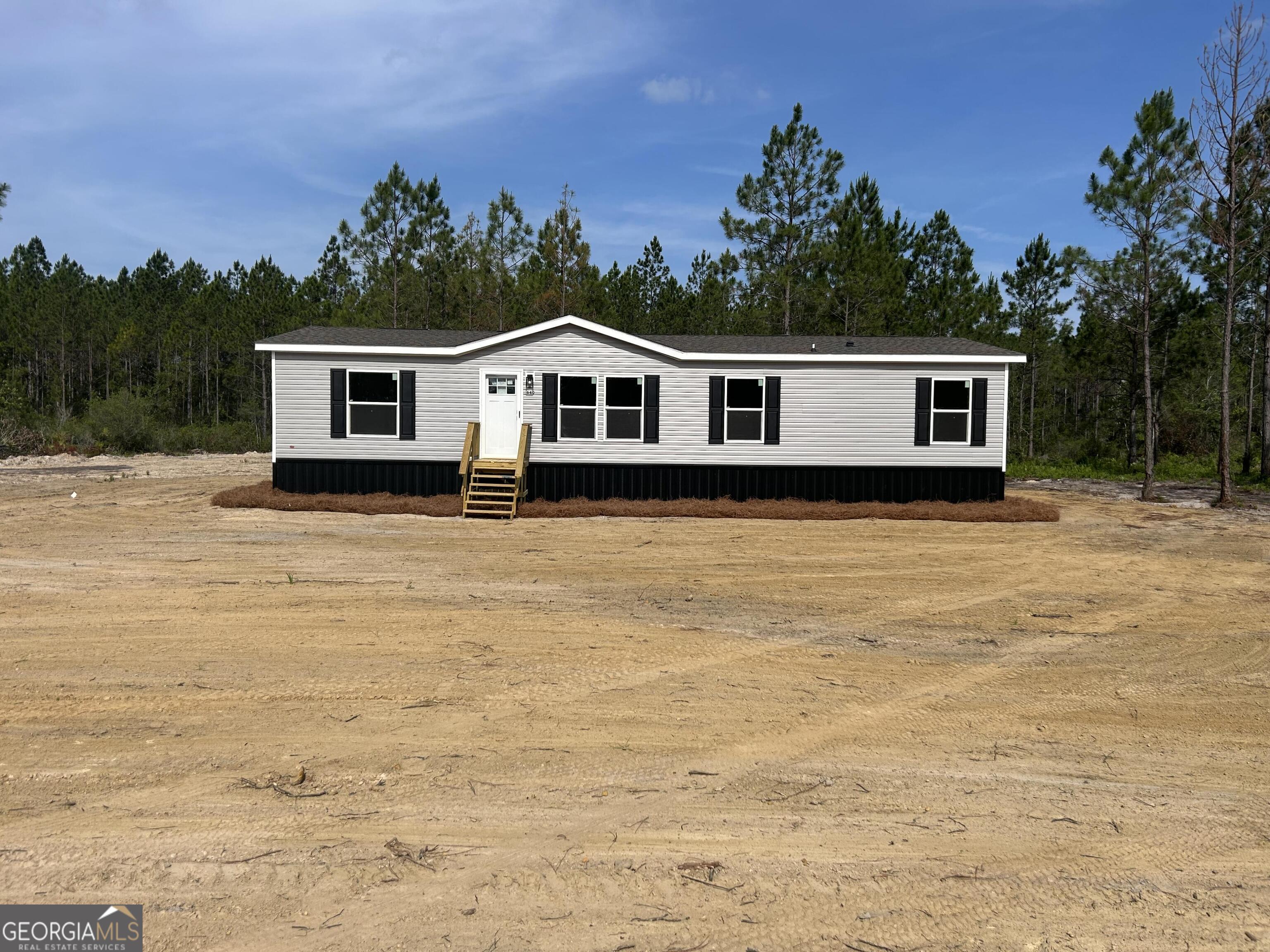 640 Elmer Thrift Road Waycross, GA 31503 - Photo 2 of 23 a house with trees in the background