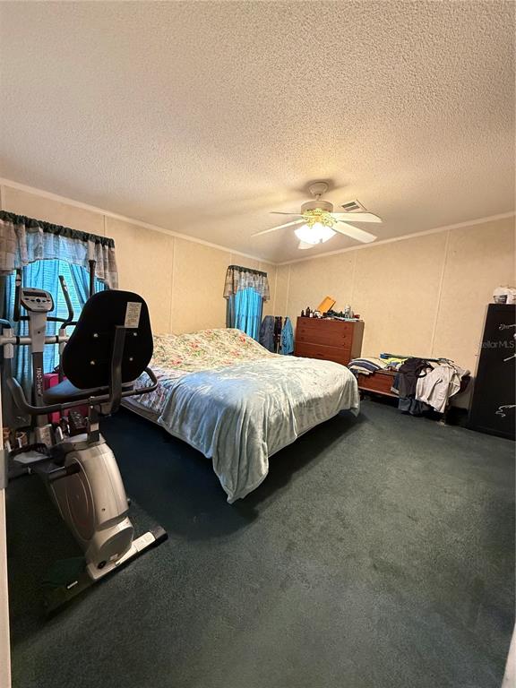 5109 Southwest 10th Street Bell, FL 32619 - Photo 5 of 38 a bedroom with a bed and a chair
