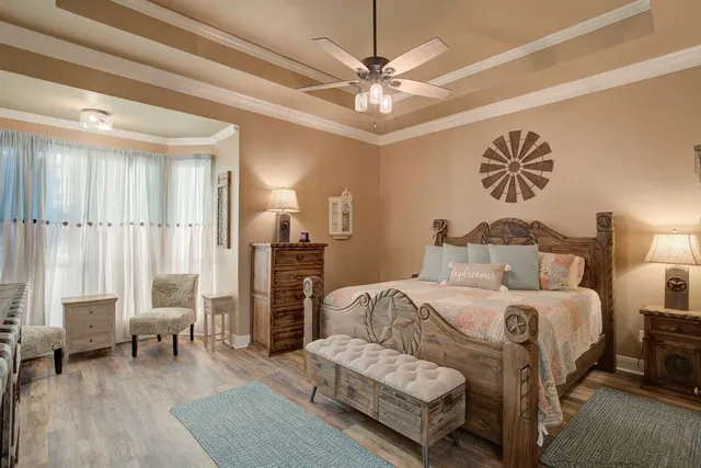 a bedroom with a bed and a chandelier