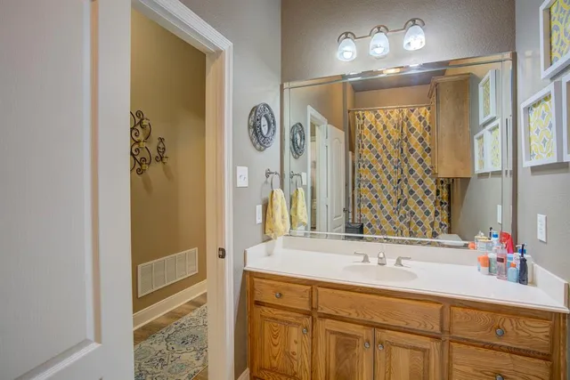 a bathroom with a sink tub and a mirror