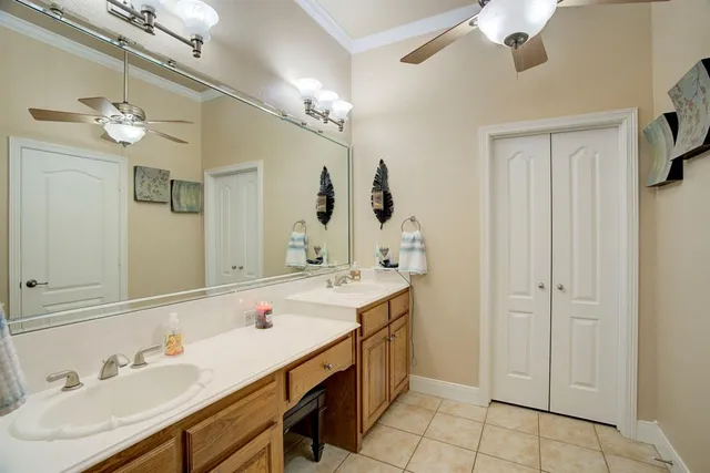 a spacious bathroom with a double vanity sink mirror and bathtub