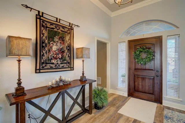 a view of an entryway with wooden floor