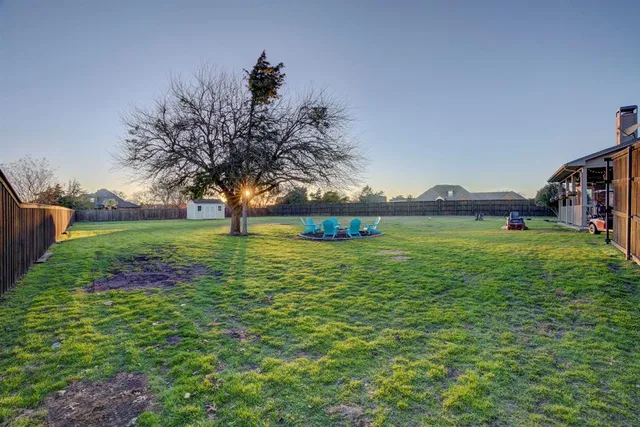 a view of yard with swimming pool and green space