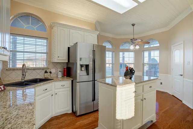 a kitchen with sink refrigerator and window