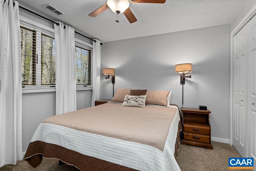 405 3 Ridges Roseland, VA 22967 - Photo 14 of 22 a bedroom with a bed and a chandelier