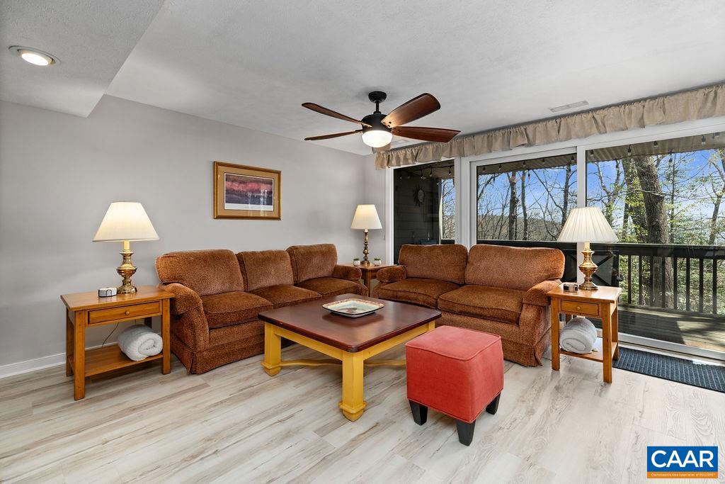 405 3 Ridges Roseland, VA 22967 - Photo 6 of 22 a living room with furniture a flat screen tv and a floor to ceiling window
