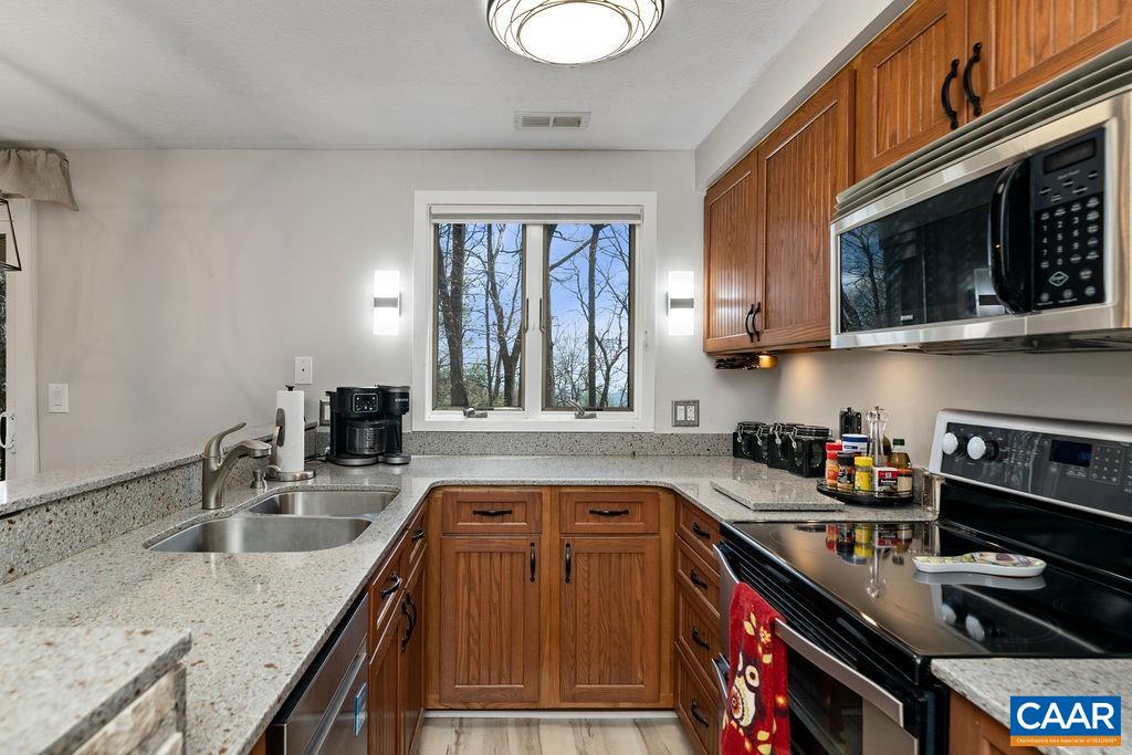 405 3 Ridges Roseland, VA 22967 - Photo 9 of 22 a kitchen with stainless steel appliances granite countertop a sink stove and cabinets