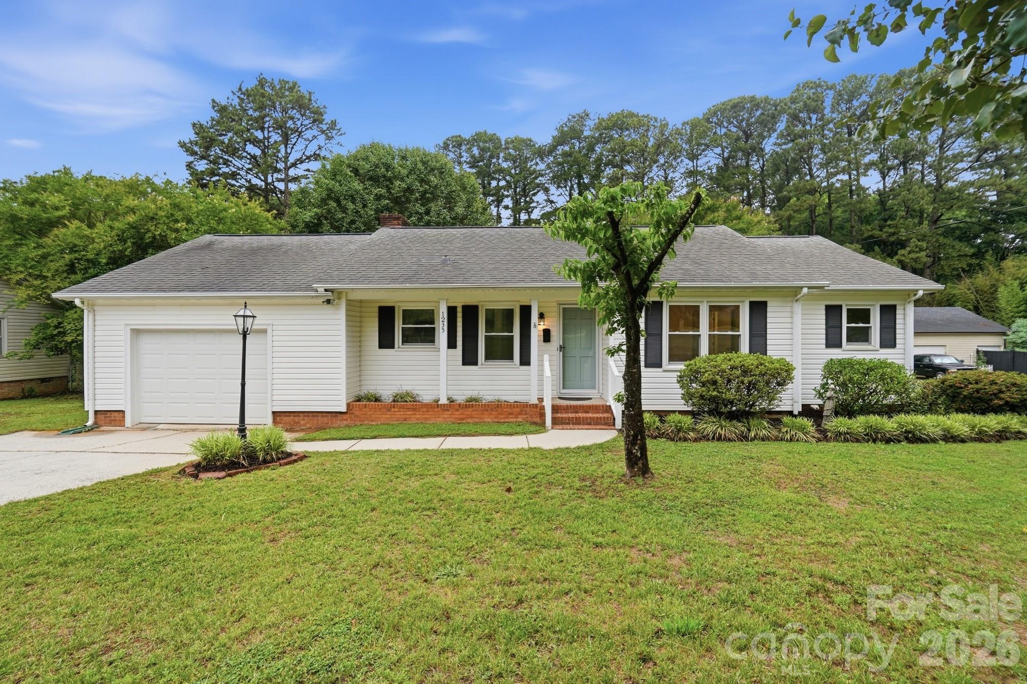 1235 Winecoff School Road Concord, NC 28027 - Photo 1 of 27 a front view of a house with a yard