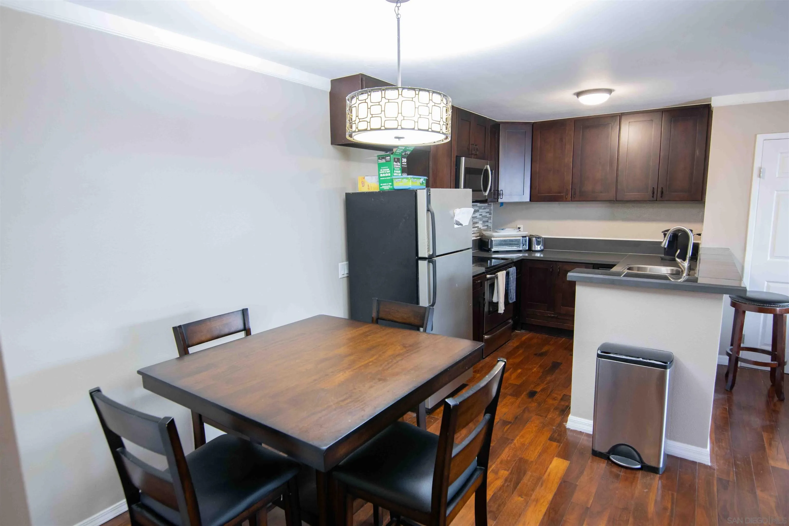 3550 Ruffin Road, Unit 145 San Diego, CA 92123 - Photo 11 of 26 a view of a dining room with furniture kitchen and wooden floor