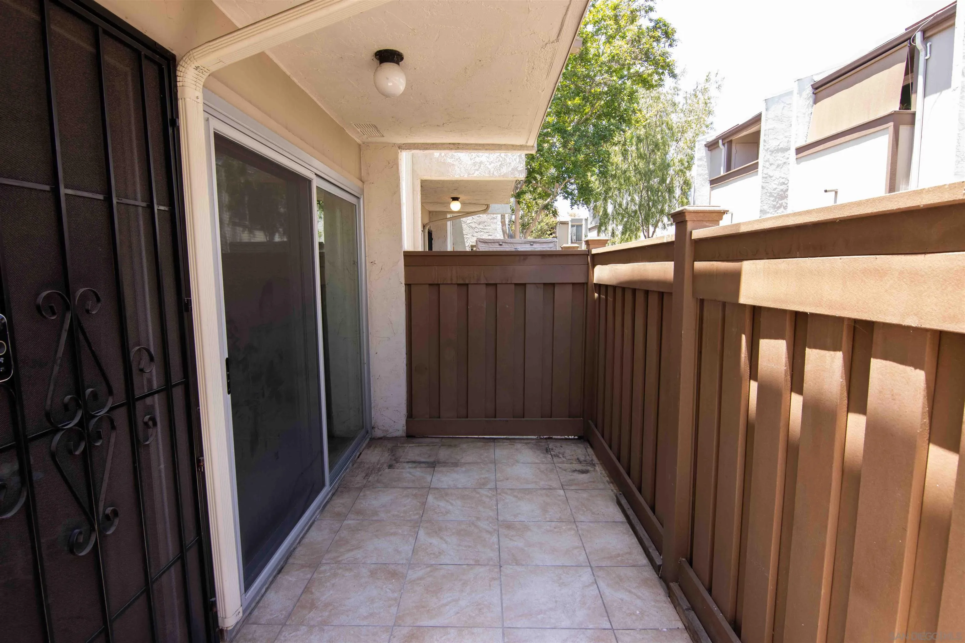 3550 Ruffin Road, Unit 145 San Diego, CA 92123 - Photo 13 of 26 a view of a house with a wooden fence