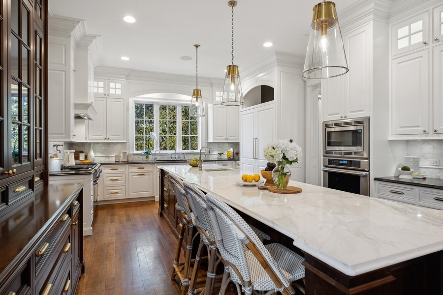 1045 Starr Road Winnetka, IL 60093 - Photo 11 of 57 a kitchen with stainless steel appliances stove refrigerator dining table and chairs