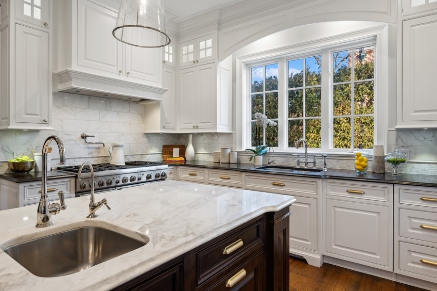 1045 Starr Road Winnetka, IL 60093 - Photo 12 of 57 a kitchen with stainless steel appliances granite countertop a sink a stove and cabinets