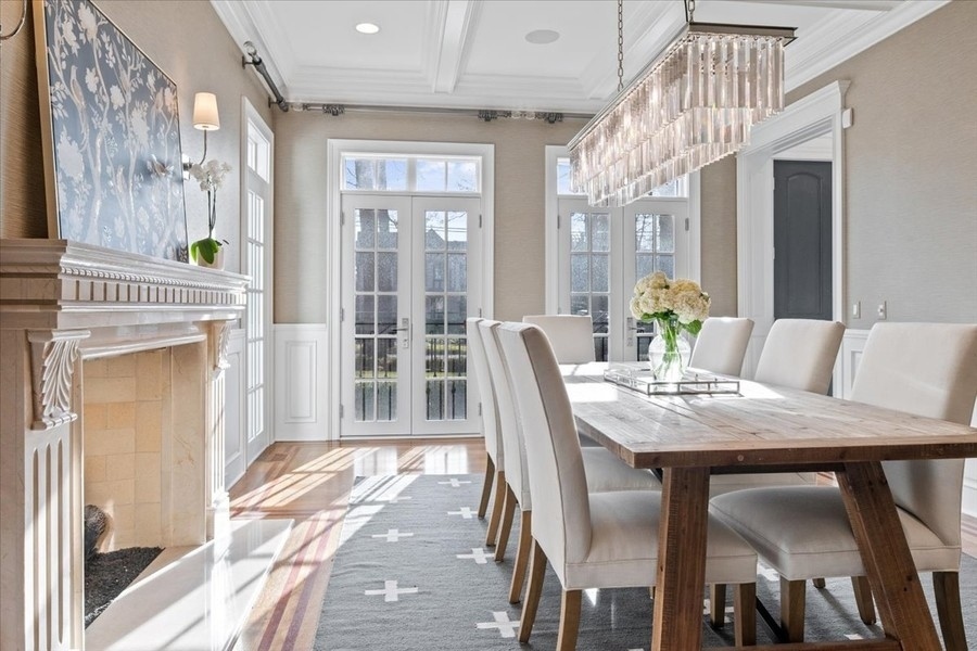1045 Starr Road Winnetka, IL 60093 - Photo 15 of 57 a view of a dining room with furniture wooden floor and a chandelier